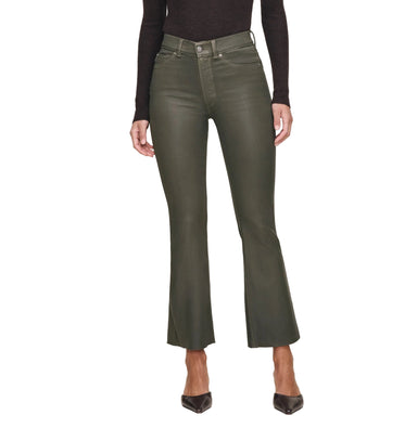 Person wearing a dark turtleneck and green pants on a white background